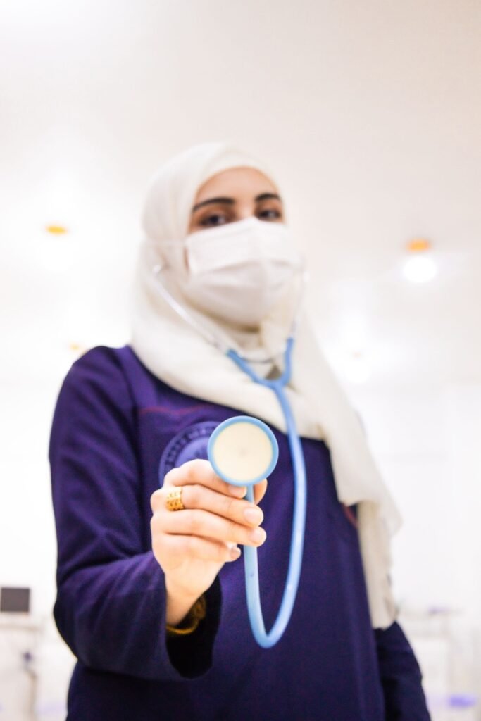 Doctor wearing a mask holding a stethoscope