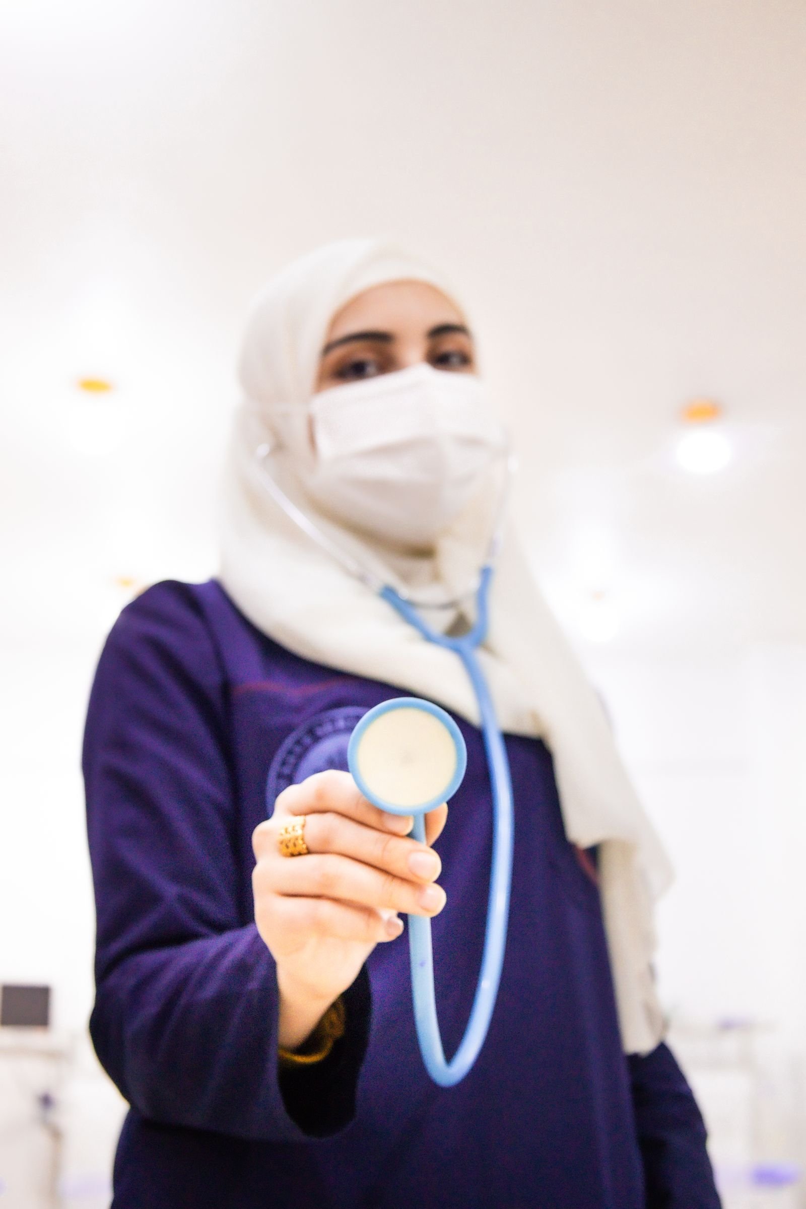 Doctor wearing a mask holding a stethoscope