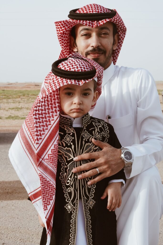 Father with his young son in traditional Saudi dress